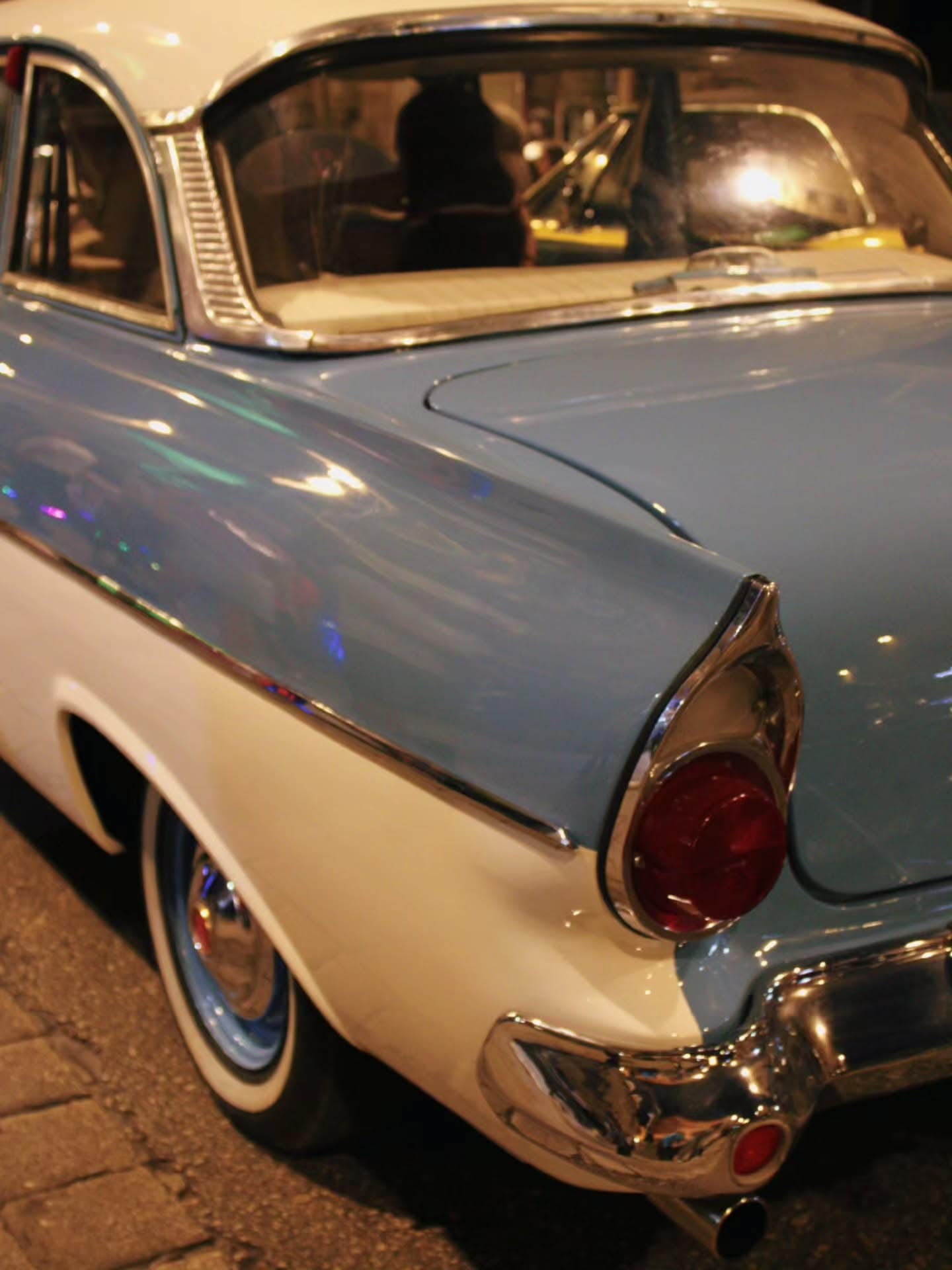 Tail fins and chrome on a 1950s coupe