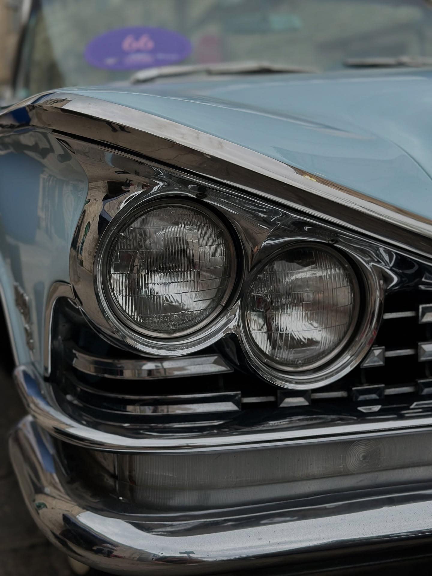Twin headlamps behind a chrome grille