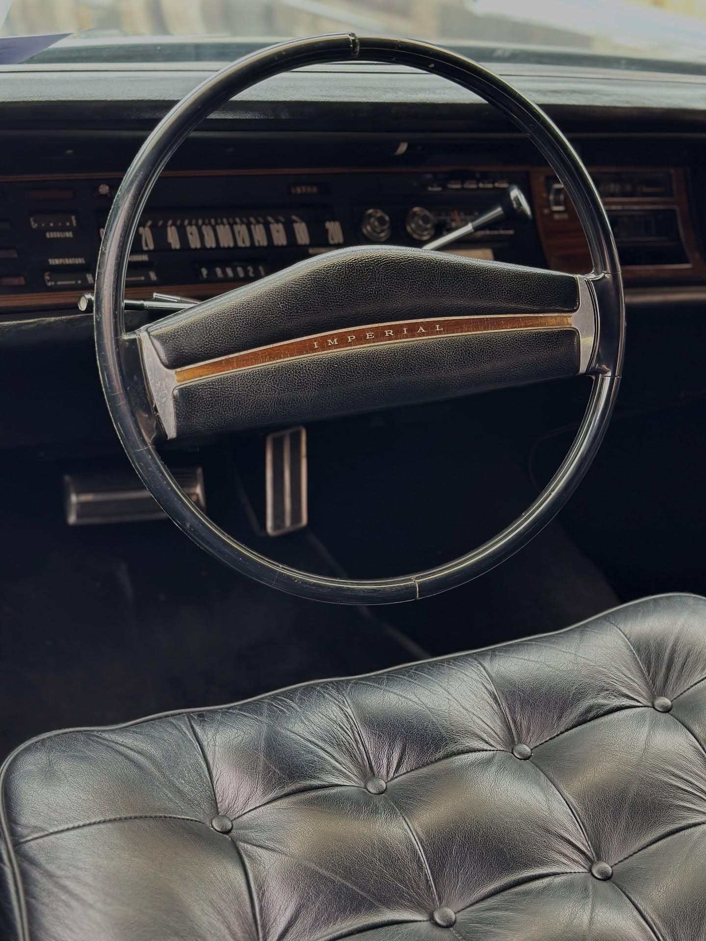 A chrome steering wheel over tufted leather