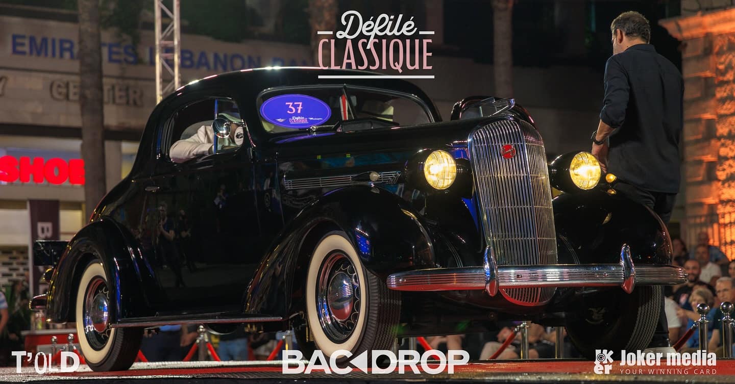 The crowned 1936 Buick on the red stage at night