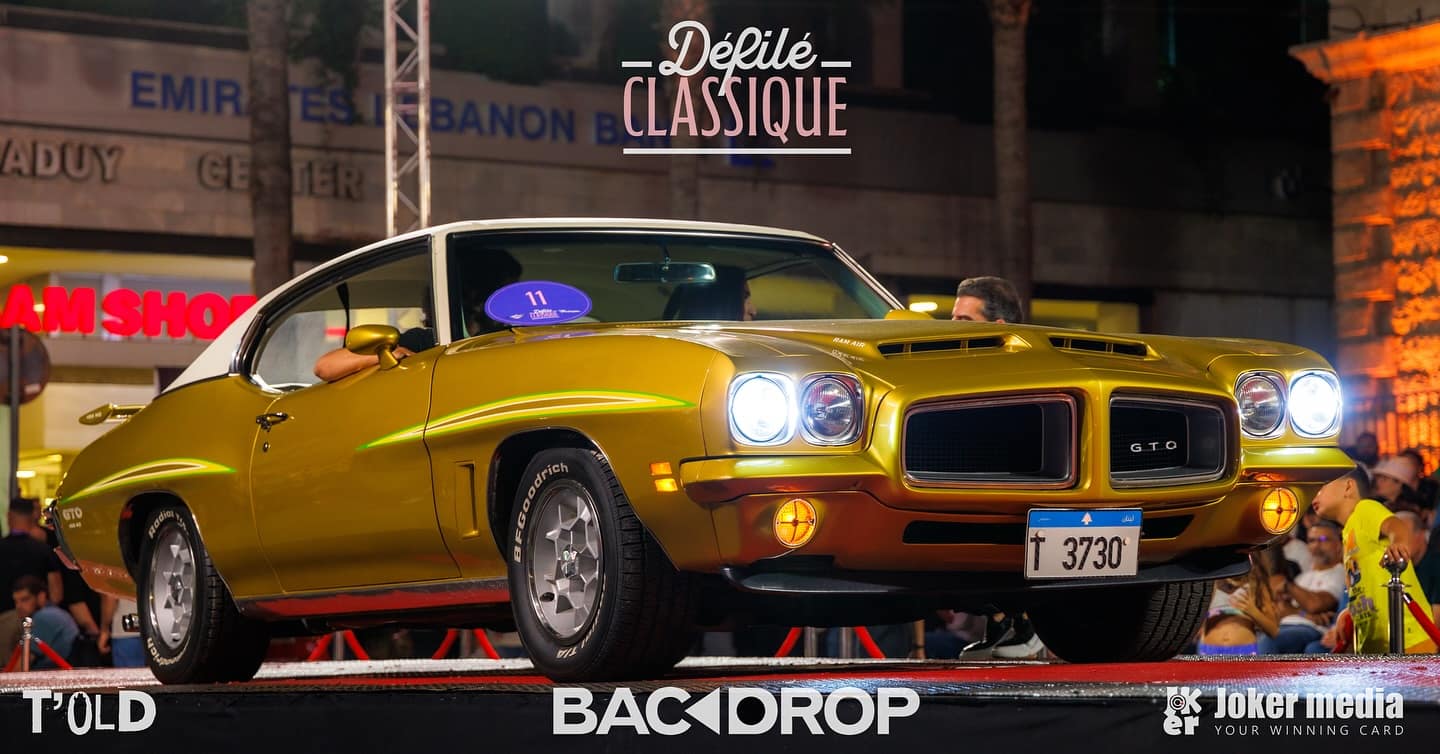 A gold 1972 Pontiac GTO 455 under the stage lights