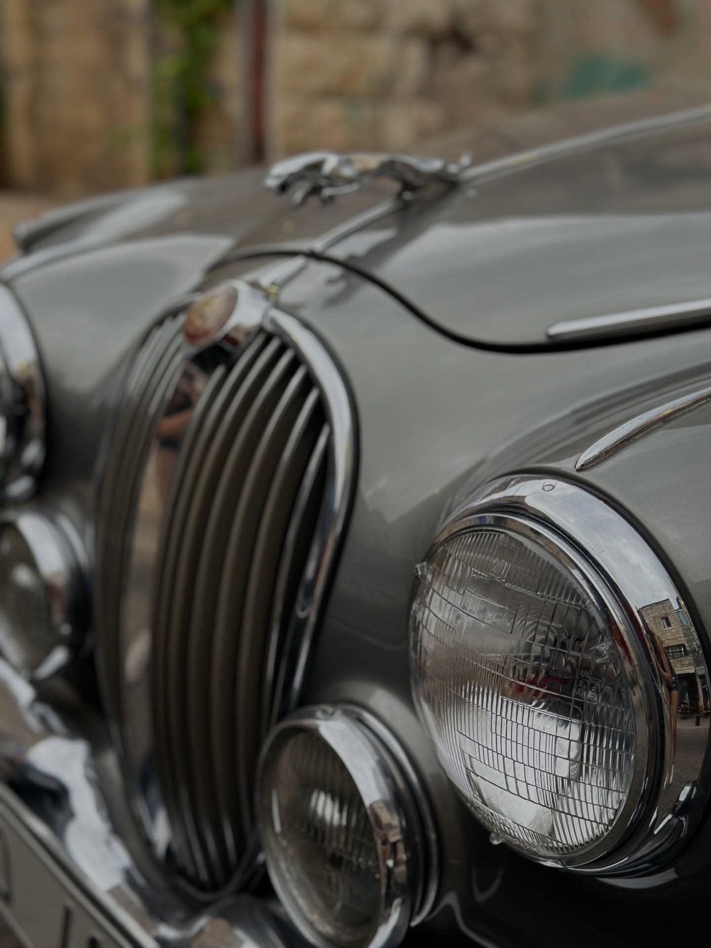 The chrome grille and headlamps of a Jaguar