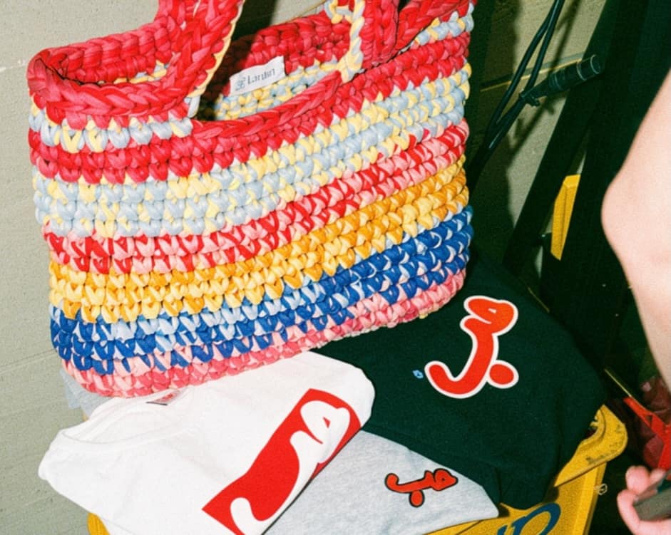 Crocheted bags and printed tees on a Vas-y market table