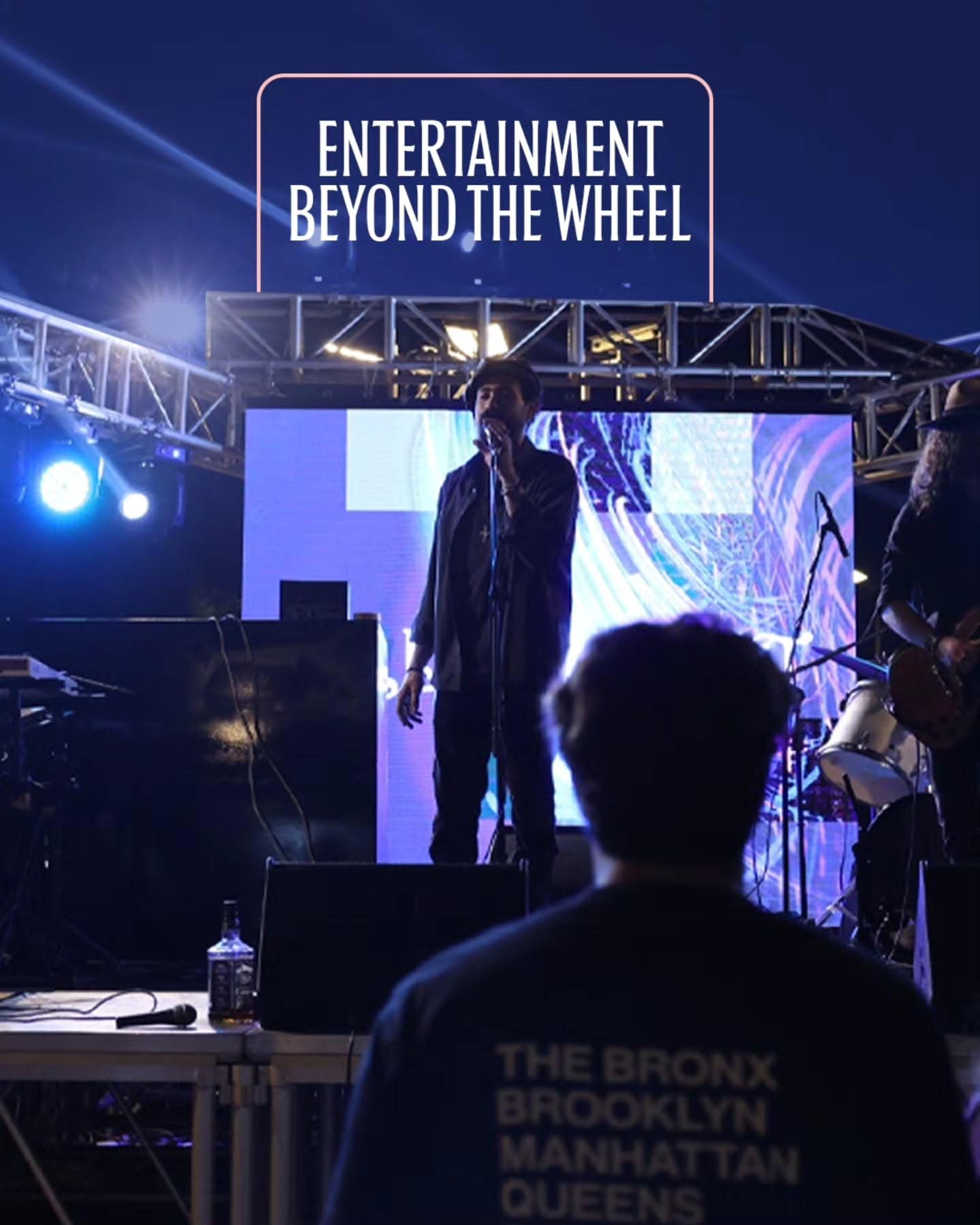 A singer on the main stage under blue lights